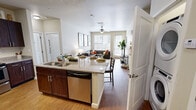 Located at 2308 Forest Ave in Knoxville, TN, this single-floor residence offers five bedrooms and four bathrooms within a thoughtfully designed layout. The open-concept kitchen serves as the heart of the home, featuring rich dark-wood cabinetry, granite countertops, stainless steel appliances — including a refrigerator, range, and microwave — and a round island with bar seating, ideal for dining and entertaining. Wood-style flooring flows through the main living areas, connecting the kitchen seamlessly to the living room, which is bathed in natural light from large windows and a glass door leading to a private balcony. A ceiling fan adds comfort to the living space. Each bedroom is carpeted and equipped with a ceiling fan, natural light from windows with blinds, and closets with built-in shelving and hanging rods. The bathrooms are consistently finished with granite-topped dark-wood vanities, large mirrors, and shower/tub combinations. The neutral color palette throughout creates a clean, cohesive aesthetic. The residence offers a functional and comfortable living environment well-suited for shared or multi-occupant living in the Knoxville area.