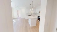 Located at 4431 Red Sage in Irvine, CA, this modern single-story residence offers 960 square feet of thoughtfully designed living space across 2 bedrooms and 3 bathrooms. The open-concept layout is anchored by a stunning kitchen featuring crisp white shaker cabinetry, a large center island with a quartz countertop, stainless steel appliances including a refrigerator, range, dishwasher, and built-in microwave, complemented by a classic tile backsplash and elegant pendant lighting. Light hardwood flooring flows throughout the main living areas, enhancing the home's bright and airy feel. The spacious living area benefits from abundant natural light streaming through large windows. The primary bedroom spans 170 square feet and includes a dedicated walk-in closet with dual hanging rods and shelving. The second bedroom features mirrored sliding closet doors and plush carpeting. Both secondary and primary bathrooms are well-appointed, with the primary bath offering a glass-enclosed walk-in shower, a wide vanity with under-mount sink, and wood-look flooring, while the second bath includes a full shower-tub combo with sliding glass doors. Three hallways connect the spaces efficiently, and the overall design maintains a clean, neutral, and contemporary aesthetic throughout.