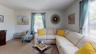 Located at 5034 Hunt Club Rd in Wilmington, NC, this single-floor home offers a well-organized layout with a variety of comfortable living spaces. The living room is an inviting area featuring carpet flooring, large windows dressed with teal curtains that allow natural light to fill the room, and ample space for relaxed seating arrangements. The kitchen is thoughtfully designed with warm wood cabinetry, a tile-effect hardwood floor, white appliances including a refrigerator, dishwasher, and electric range, as well as a peninsula breakfast bar with seating — ideal for casual dining. Multiple bedrooms provide versatile accommodation options. The primary bedroom features carpet flooring, a ceiling fan, a spacious sliding-door closet, and a window offering natural light. A second bedroom offers carpet flooring and a built-in wall desk with shelving, making it well-suited as a guest room or home office. A third bedroom features carpet flooring and generous window exposure. The bathrooms are cleanly finished, with one featuring a walk-in style shower and hardwood-look flooring. Throughout the home, neutral wall tones and consistent flooring choices create a cohesive and welcoming atmosphere across all spaces.