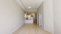This well-designed two-storey residence at 527 Carnarven offers 4 bedrooms and 3 bathrooms spread evenly across two floors of comparable size. The main floor features an open-concept living and kitchen area finished with light hardwood-style flooring and neutral warm-toned walls that create a bright, airy atmosphere. The kitchen is a standout feature, equipped with stainless steel appliances, a large peninsula with a white quartz countertop, a double undermount sink, and a combination of high-gloss white upper cabinetry and warm wood-toned lower cabinets, all complemented by a white tile backsplash. A staircase leads to the upper floor, where four bedrooms are situated, including a generously sized primary bedroom. The bedrooms feature the same light flooring, clean white walls, and large windows that invite natural light and offer views of the surrounding neighbourhood. The bathrooms are finished with large-format tile flooring and modern fixtures. One bathroom includes a glass-enclosed walk-in shower with mosaic tile accents and a wood-grain vanity with a white countertop. An additional powder room provides accessible features. The overall ambiance of the space is clean, contemporary, and functional.