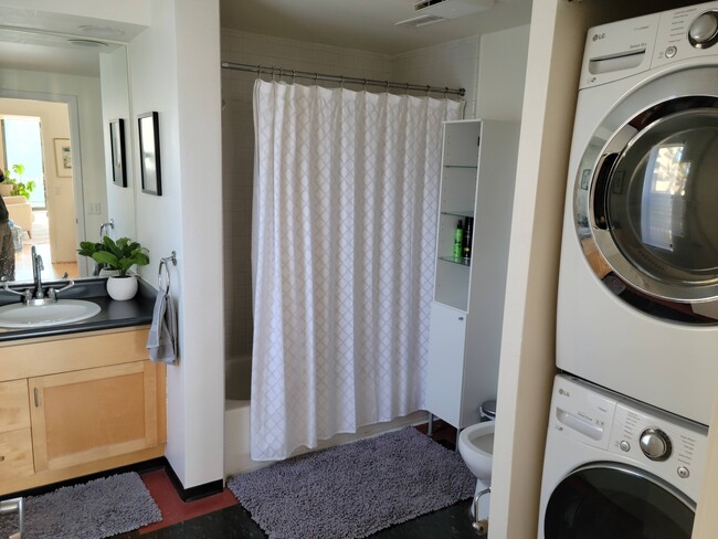 Bathroom tub and shower with Laundry/Dryer in unit - 81 Lansing St