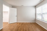 Located at 628 Calderone St in South Plainfield, NJ, this thoughtfully updated single-floor space showcases a cohesive blend of modern finishes and functional design throughout. The open living and dining area is anchored by warm hardwood flooring, neutral gray walls, and flush ceiling lighting, creating a bright and versatile space. A pass-through opening connects this area seamlessly to the kitchen, enhancing the open-concept feel.

The kitchen is a standout feature, finished with sleek high-gloss white cabinetry, a dramatic marble-look backsplash, and matching large-format marble-style tile flooring. Stainless steel appliances — including a dishwasher, over-the-range microwave, and a bold black gas range — complete this contemporary culinary space.

Bedrooms are generously proportioned, featuring the same warm hardwood floors, large windows that invite natural light and garden views, and ample closet space with double-door closets. The neutral palette throughout provides a clean, move-in-ready canvas.

The bathrooms are finished to a high standard, featuring textured wood-tone wall tiles, stone-look floor tiles, warm wood vanities with integrated white sinks, and sleek matte black fixtures and hardware. One bathroom includes a soaking tub, while the other offers a walk-in shower, offering flexible options for residents.
