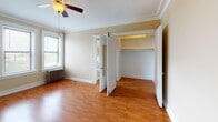 Located at 5254 S Dorchester Ave in Chicago's Hyde Park neighborhood, this single-floor unit offers a functional and straightforward layout. The living area features warm hardwood flooring throughout, complemented by crown molding along the ceiling and a ceiling fan with light fixture, lending a classic character to the space. Neutral-toned walls provide a clean, versatile backdrop.

The kitchen is efficiently arranged and open to the living area via a pass-through counter, making the space feel connected. It includes rich wood cabinetry offering ample storage, granite-style countertops, a stainless steel sink, and a gas range, providing all essential cooking amenities.

The bedroom continues the hardwood flooring and crown molding found throughout, with a ceiling fan, a window allowing natural light, a radiator for heating, and a spacious open closet providing generous storage. Bifold doors lead conveniently to the adjacent bathroom.

The bathroom features white tile wainscoting, warm upper wall tones, a frosted window for natural light and privacy, a soaking tub, pedestal-style sink, and a mirrored medicine cabinet, creating a clean and practical space. Overall, the unit presents a cohesive, classic Chicago aesthetic.