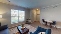 This two-floor residence on Rice Creek Parkway in Shoreview, Minnesota presents a thoughtfully designed layout with consistent modern finishes throughout. The living area features light hardwood-style flooring, crown molding, and a large window that fills the space with natural light and offers views of the surrounding neighborhood. The room comfortably accommodates a seating area and a small dining nook near the entry.

The kitchen is a standout feature, showcasing rich dark cabinetry that extends to the ceiling for ample storage, granite countertops, stainless steel appliances, and a peninsula with seating—ideal for casual dining or entertaining. Recessed lighting and crown molding carry the refined aesthetic throughout.

Bedrooms are carpeted for comfort, with neutral tones and natural light from windows. The primary bedroom includes access to a generously sized walk-in closet with wire shelving and a private en-suite bathroom featuring a glass-enclosed shower, granite vanity, and dark cabinetry. An additional half bath with a pedestal sink provides convenient secondary access. The overall ambiance is clean, neutral, and move-in ready, reflecting a well-maintained and contemporary residential design.