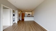 Located at 1620 N Water Street in Milwaukee's vibrant River West neighborhood, this single-floor unit showcases a clean, contemporary design with a thoughtful layout. The open-concept living and kitchen area is anchored by wood-look plank flooring that runs throughout the main spaces, creating a cohesive and modern aesthetic.

The kitchen is well-appointed with white cabinetry, a white subway tile backsplash, granite countertops, and a full suite of stainless steel appliances, including a refrigerator, range, and microwave. A peninsula with a granite countertop overhang defines the kitchen space while maintaining an open connection to the living area. Pendant lighting above the peninsula adds a stylish finishing touch.

The living area benefits from large sliding glass doors that open to an outdoor balcony, filling the space with natural light. Bedrooms feature plush carpet, individual wall-mounted climate control units, and walk-in closets. The bathroom is outfitted with wood-look flooring, a soaking tub and shower combo, granite vanity countertop, and white cabinetry. A dedicated in-unit laundry closet with a stacked washer and dryer adds everyday convenience.