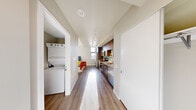 Located at 809 S Washington St in Seattle's historic Pioneer Square neighborhood, this thoughtfully designed studio offers a smart, efficient layout that maximizes every square foot. The open-plan living area features light wood-style flooring throughout, neutral walls, and track lighting that keeps the space bright and contemporary. Large windows draw in generous natural light and provide views of the surrounding urban landscape.

The galley-style kitchen is well-appointed with stainless steel appliances, including a full-size refrigerator, electric range, and built-in microwave. Rich, dark wood cabinetry paired with a light tile backsplash and granite-style countertops gives the kitchen a polished, modern aesthetic. A dedicated nook houses a stacked washer and dryer unit, providing the convenience of in-unit laundry.

The open living and sleeping area comfortably accommodates both lounging and rest, with a wall-mounted mini-split HVAC system ensuring year-round climate comfort. The full bathroom features wood-toned cabinetry, granite countertops, hardwood-style flooring, and a glass-enclosed shower. Clean lines and a cohesive neutral palette create a calm, functional ambiance throughout this well-designed urban studio.
