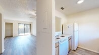 Located at 5565 Connie Jean Rd in Jacksonville, FL, this single-story, 3-bedroom, 1-bathroom home offers a functional and comfortable layout. Throughout the home, light-toned luxury vinyl plank flooring creates a clean, cohesive look that ties each room together.

The open living area is bright and airy, featuring a ceiling fan with light fixture, a textured ceiling, and sliding glass doors that provide natural light and direct access to an outdoor patio area. The galley-style kitchen is equipped with warm wood cabinetry, light countertops, a double sink, a white refrigerator, and an electric range, offering efficient use of space.

The generously sized primary bedroom stands out as the largest room in the home, complete with dual closets featuring built-in shelving and sliding glass door access to the backyard. The additional bedrooms are well-proportioned, each with windows that bring in natural light and closets with shelving for organized storage.

The shared bathroom includes a full tub-shower combo, a white vanity, and chrome fixtures, maintaining a clean and practical design. The home's neutral color palette and consistent flooring throughout create a bright, move-in-ready atmosphere suited for everyday living.