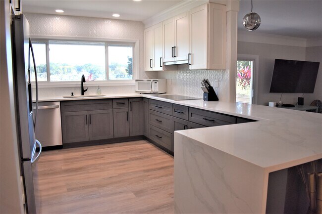 Marble-look quartz countertop with waterfall edge - 6325 Kellow Dr