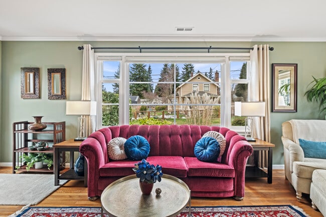 Sun-filled living room with peaceful neighborhood views. - 11639 1st Ave NW
