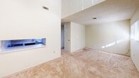 Located at 220 Brown West Dr in Rockwood, Tennessee, this two-bedroom, one-bathroom residence is laid out entirely on a single floor, offering a straightforward and functional floor plan. The living area features neutral-toned carpet and a notably elevated ceiling section, creating an open, airy feel despite the compact footprint. A pass-through window connects the living space to the kitchen area, which is equipped with cabinetry and standard appliances, adding a practical and efficient touch to the layout.

Both bedrooms are carpeted and finished in soft, neutral tones with textured ceilings. Each room benefits from generous natural light — one bedroom features a large sliding glass door with vertical blinds that open to an outdoor view of surrounding greenery, while the other includes a standard window overlooking the exterior. Closet space is well-represented, with the primary bedroom featuring its own dedicated closet and an additional hallway closet providing supplementary storage.

The bathroom includes a wide vanity with a solid-surface countertop, an integrated sink, and a full shower-tub combination. A grab bar is also present, adding an accessibility-conscious detail. A connecting hallway ties the rooms together cohesively, completing this tidy and well-organized single-level residence.