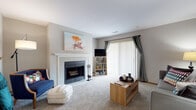 Located at 6800 S Parkedge Cir in Franklin, Wisconsin, this single-floor home offers a thoughtfully designed layout with a comfortable blend of functional living spaces. The living room serves as a central gathering area, highlighted by a classic wood-burning fireplace with a white tile surround and wood mantel, plush carpeting, and a sliding glass door with vertical blinds that fills the space with natural light. The kitchen is appointed with warm oak cabinetry, ample counter space with granite-style laminate countertops, and durable hardwood-style flooring, providing generous storage and prep space. Adjacent to the kitchen, a dedicated dining area features hardwood-style flooring and enough space to accommodate a full dining table, making it well-suited for everyday meals and entertaining. The primary bedroom is generously sized with soft carpeting and natural light from large windows. A second bedroom also offers carpeted flooring, natural light, and comfortable proportions. Two full bathrooms are present in the home, each featuring oak vanities, tile flooring, and shower-tub combinations. Overall, the home presents a warm and practical living environment in a residential Franklin neighborhood.
