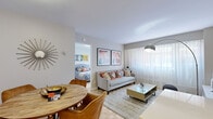 Located on Rue Crescent in the heart of Montréal, this well-designed one-bedroom, one-bathroom unit makes efficient use of its compact footprint across a single floor. The layout is thoughtfully organized, with distinct living, dining, and kitchen zones that flow seamlessly into one another.

The kitchen features white upper cabinetry, stainless steel appliances, and a wood-paneled island with a white countertop and bar seating, providing both prep space and casual dining functionality. Adjacent to the kitchen, a dedicated dining area accommodates a round wood table with upholstered chairs, completing the open-concept entertaining space.

The living room benefits from a large window dressed with sheer curtains that allow natural light to fill the room. Classic parquet flooring runs throughout the unit, adding warmth and character to each space.

The bedroom is a calm, private retreat with a wide window offering natural light, parquet flooring, and ample wall space. The bathroom features a clean, modern design with white cabinetry, a undermount sink, white countertop, and a large mirror with recessed lighting above.

Overall, the unit presents a bright, cohesive aesthetic with neutral tones accented by warm, earthy furnishing choices throughout.