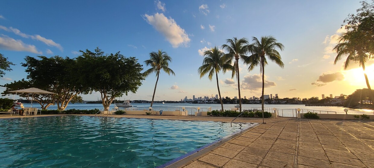 West facing view with infinity pool and deck over water. - 3 Island Ave