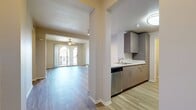 This contemporary apartment in Rancho Cucamonga offers 1080 square feet of thoughtfully designed living space. The single-story layout encompasses three bedrooms, including a primary bedroom of 140 square feet, and two full bathrooms. The heart of the home is a modern kitchen featuring sleek cabinetry, a built-in microwave, and stainless steel appliances, complemented by a convenient breakfast bar.

The living room is a highlight, boasting wood-look flooring and large sliding glass doors that flood the space with natural light and provide access to an outdoor area. Each bedroom is carpeted for comfort and includes closet space, with the primary bedroom featuring a larger closet for additional storage. The bathrooms are fitted with modern fixtures and tiled surrounds.

Practicality meets style with an in-unit laundry area, ensuring convenience for residents. The apartment's neutral color palette and contemporary finishes create a fresh, inviting atmosphere throughout. With its efficient use of space and modern amenities, this apartment offers a comfortable and stylish living environment in a desirable Rancho Cucamonga location.