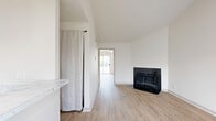 Located at 1540 Chenault St in Dallas, TX, this well-appointed one-bedroom, two-bathroom home offers a thoughtful layout across a single floor. The living room serves as the heart of the home, boasting dramatic vaulted ceilings that create an airy, open feel, complemented by a striking black-tiled fireplace and light wood-style flooring that runs throughout the space. Natural light filters in through window blinds, keeping the atmosphere bright and inviting.

The kitchen is efficiently designed with taupe cabinetry, marble-look countertops, a herringbone tile backsplash, and black appliances including a range and over-the-range microwave. A pass-through counter connects the kitchen to the living area, enhancing the open flow of the home.

The spacious primary bedroom features a ceiling fan, a natural light-filled window, and access to a dedicated closet. Both bathrooms are cleanly finished, with one featuring a dual-sink vanity with marble-look countertops and warm wood cabinetry, and the other offering a full tub-shower combination with brushed nickel fixtures.

Consistent light wood-style flooring, neutral walls, and clean finishes throughout give this home a cohesive, move-in-ready aesthetic.