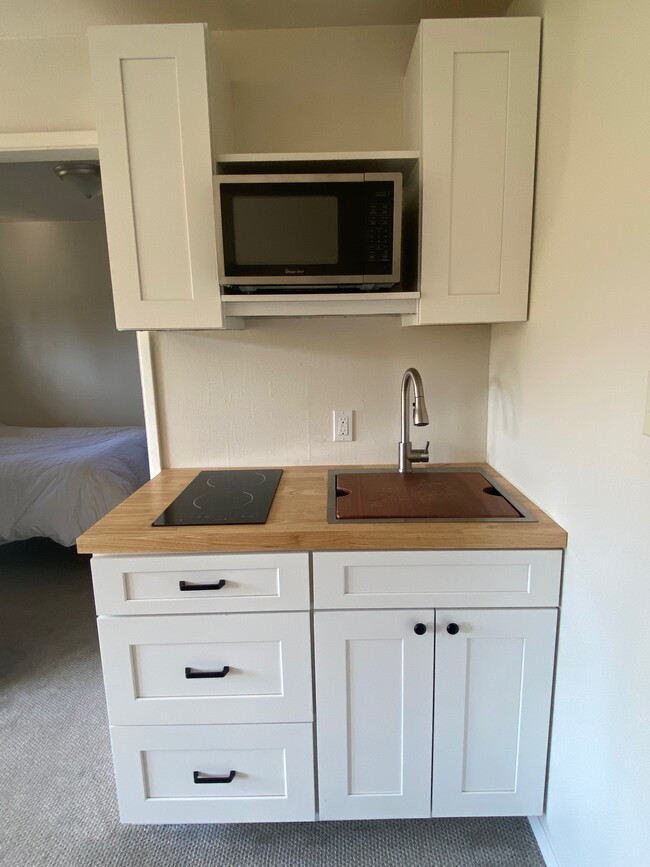 kitchenette w/sink, cooktop and microwave plus dishes and glass, etc - 545 S 5th St