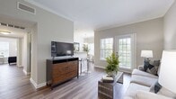 This 800 square foot apartment in Hermitage, Nashville, offers a thoughtfully designed living space with two bedrooms and two bathrooms. The open-concept floor plan combines the kitchen, dining, and living areas, creating a seamless flow for daily activities and entertaining. The kitchen boasts dark wood cabinetry, granite countertops, and black appliances, providing both style and functionality.

The primary bedroom, measuring 180 square feet, features a large closet and ample natural light. Both bedrooms are equipped with comfortable furnishings and neutral color schemes, promoting a restful atmosphere. The bathrooms are clean and modern, with one featuring a bathtub for added convenience.

Throughout the apartment, wood-look flooring adds warmth and durability. Large windows with white blinds allow for plenty of natural light while offering privacy when needed. The living room opens to a small balcony or patio, extending the living space outdoors.

Additional amenities include an in-unit laundry room with full-sized washer and dryer, ensuring convenience for residents. The overall design aesthetic combines contemporary elements with a neutral color palette, creating a versatile canvas for personal style. This apartment offers a comfortable and efficient living solution in a prime Nashville location.
