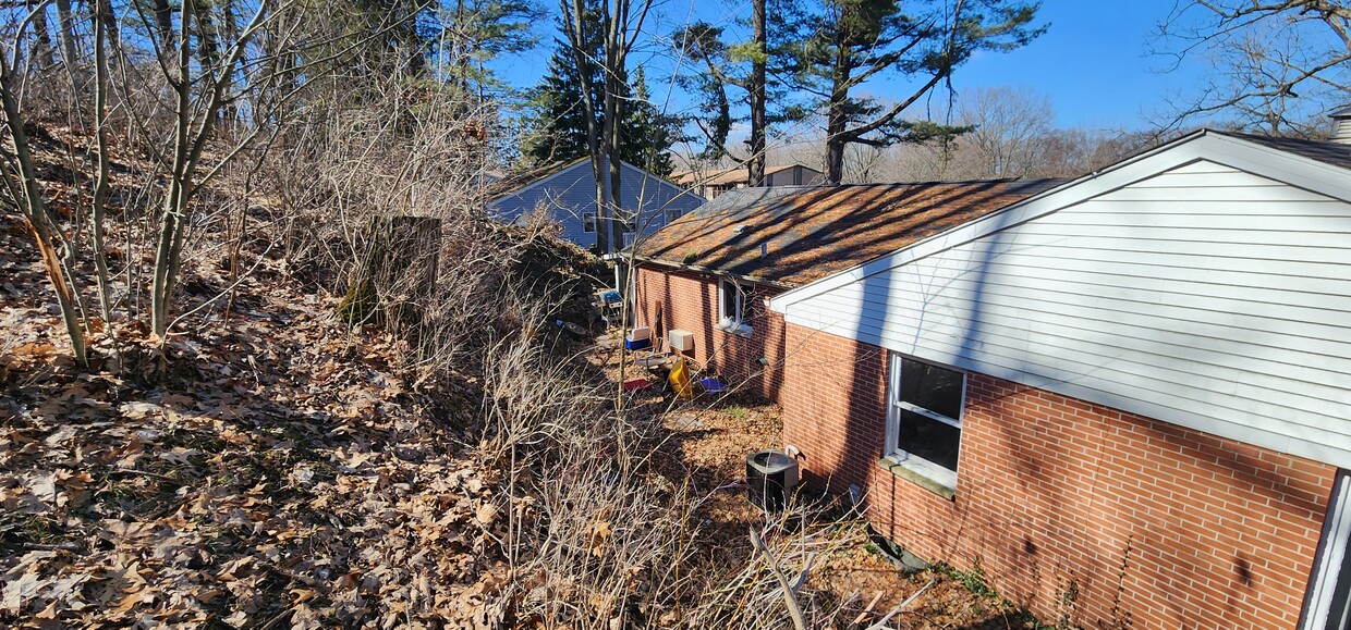 small back yard area of 3703, retaining wall then hill shileds from wind. - 3703 Winchell Ave