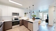 Located on S Weber St in Colorado Springs, CO, this modern 1-bedroom, 1-bathroom residence offers a thoughtfully designed open-concept layout with contemporary finishes throughout. Light wood-tone flooring flows seamlessly across the single-floor plan, complementing the clean, neutral color palette.

The kitchen is a standout feature, showcasing two-tone cabinetry with white upper cabinets and dark wood lower cabinets, white subway tile backsplash, stone-look countertops, stainless steel appliances, and a peninsula with seating for three. Three matte black pendant lights add a stylish focal point. The kitchen opens directly to the living room, which benefits from large windows, a ceiling fan, and access to a private patio with neighborhood views.

The bedroom offers generous proportions, large windows with outdoor views, light-filled walls, and direct access to the full bathroom. The bathroom features a stone-look vanity countertop, dark wood cabinetry, and leads to a walk-in closet with built-in shelving. A second closet and a utility room add practical storage. Exposed concrete accent elements throughout lend an industrial-modern touch to this well-appointed Colorado Springs residence.