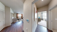 Located at 500 Chris Kelley Blvd in Hutto, TX, this single-story, one-bedroom, two-bathroom residence offers a well-designed layout with comfortable living spaces throughout. The open-concept kitchen and living area serves as the heart of the home, anchored by a large granite-topped island with bar seating and pendant lighting overhead. Rich dark wood cabinetry, stainless steel appliances, and hardwood-style flooring complete the kitchen, which flows seamlessly into the dining and living areas. The living room is bright and inviting, featuring large windows with views of the outdoors and a ceiling fan overhead. A glass door provides additional natural light and exterior access. The spacious primary bedroom features plush carpet, generous windows that bring in abundant natural light, and direct access to one of two full bathrooms. Both bathrooms are finished with tile flooring, granite vanity countertops, dark wood cabinetry, and a tub-shower combination. Each bathroom connects to its own dedicated walk-in closet, outfitted with wire shelving for ample storage. A hallway connects the main living areas to the private bedroom suite, creating a functional and cohesive floor plan throughout.