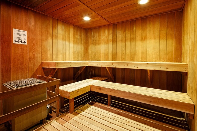 Experience the ultimate relaxation in this luxurious wooden sauna, designed for comfort and tranquility. - Timberline Place Apartments