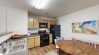 Located at 830 Allonby Rd in Fayetteville, NC, this single-story, 2-bedroom, 2-bathroom home offers a thoughtfully designed layout that makes excellent use of its space. The open-concept kitchen and living area serves as the heart of the home, featuring light wood cabinetry, dark granite-style countertops, black appliances including a refrigerator and electric range, and wood-look flooring. A dedicated dining nook flows naturally from the kitchen, providing an inviting space for meals. The spacious living room is bathed in natural light from multiple windows with sheer curtains, creating a bright and airy atmosphere. The primary bedroom is a comfortable retreat, complete with plush carpeting, a ceiling fan, and a closet. The second bedroom also features carpeted flooring, a closet, and a window for natural light. Both bathrooms are well-appointed, with one featuring a tub-shower combination, wood-look flooring, a granite-topped vanity, and dark wood cabinetry. Additional conveniences include a pantry, a dedicated laundry area, hallway access between rooms, and ample closet storage throughout. The overall ambiance is clean, bright, and functional, making this an ideal home in the Fayetteville area.