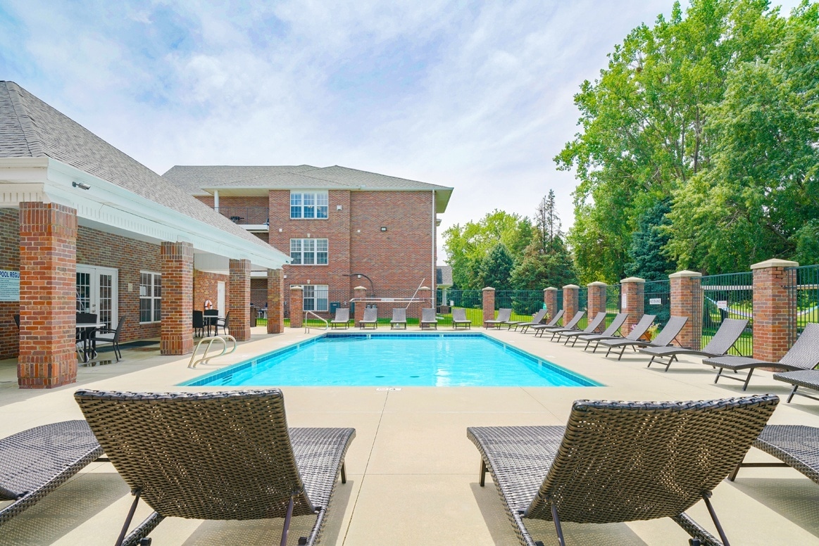 Sunbathe and enjoy the water in our seasonal swimming pool. - Williamsburg Park Apartments