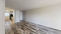 Located at 2827 S Emporia St in Wichita, Kansas, this single-floor, 2-bedroom, 2-bathroom unit offers a practical and well-appointed layout. The living room features durable wood-look plank flooring, neutral gray walls, and a textured ceiling, creating a clean and understated aesthetic. A dedicated closet and entry door are conveniently positioned off the main living area.

The kitchen is designed for functionality, featuring gray cabinetry, granite-style countertops, black appliances including a range and refrigerator, a stainless steel sink, and wood-look flooring that continues from the living area. A window allows natural light to brighten the space.

Both bedrooms are carpeted for comfort and equipped with ceiling fans with lighting. Each room features neutral tones, blinds for light control, and ample closet space, including a bifold closet in one bedroom. The spacious primary bedroom offers a well-sized footprint suitable for a full furniture arrangement.

The two bathrooms each include a full tub-shower combo with clean white surrounds and gray cabinetry for storage. Textured ceilings are consistent throughout the unit, contributing to a cohesive finish. The overall design is straightforward and functional, offering comfortable, move-in-ready living in a single-story layout.