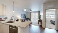 Located in Gilbert, AZ, this thoughtfully designed one-bedroom, one-bathroom residence offers a well-appointed single-floor layout that maximizes comfort and functionality. The open-concept kitchen and living area serves as the heart of the home, where light wood cabinetry, granite countertops, and a full suite of stainless steel appliances — including a refrigerator, range, and microwave — create an efficient and stylish culinary space. A breakfast bar with seating for three connects seamlessly to the living area, which is brightened by natural light streaming through large sliding glass doors. These doors open to a private balcony, extending the living space outdoors. A ceiling fan overhead adds comfort to the airy living room. Wood-style flooring flows throughout the main living areas, adding warmth and continuity. The bedroom is a quiet retreat featuring plush carpeting, generous natural light from a large window, and direct access to the walk-in closet. The bathroom is finished with a granite-topped vanity, modern cabinetry, wood-style flooring, and a glass-enclosed shower. The walk-in closet offers organized shelving and hanging space. Clean lines, neutral tones, and modern finishes throughout give this residence a polished, contemporary character.