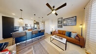 This well-appointed one-bedroom, one-bathroom unit in Northglenn, Colorado offers a thoughtfully designed open-concept floor plan that maximizes every inch of its comfortable footprint. The living room is bright and welcoming, with large windows that flood the space with natural light, light wood-style flooring, and a ceiling fan overhead. It flows seamlessly into the modern kitchen, which features a large central island with granite countertops and seating, bold two-tone cabinetry with dark lower cabinets and white upper cabinets, a teal tile backsplash, and stainless steel appliances including a refrigerator, range, and dishwasher. Pendant lighting above the island adds a polished touch. The bedroom offers a cozy retreat with plush carpeting and ample closet space. The bathroom is clean and contemporary, with wood-look tile flooring, a dark vanity with stone countertop, and a full soaking tub with shower. A dedicated in-unit laundry area accommodates a full-size washer and dryer. Additional highlights include three closets for generous storage and a private balcony for outdoor enjoyment. The unit's modern aesthetic, abundant natural light, and functional layout make it an attractive and comfortable living space.