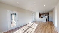 Located at 4550 Falmer Dr in Bethlehem, PA, this well-appointed single-floor home offers two bedrooms and two full bathrooms within a thoughtfully designed layout. Light-toned hardwood-style flooring runs throughout, tying together a clean, modern aesthetic enhanced by neutral walls and recessed lighting.

The open living area is bright and welcoming, with large windows and a glass-panel door that invite abundant natural light and provide views of the outdoors. The kitchen is efficiently laid out and well-equipped, featuring dark gray shaker-style cabinetry, white countertops, stainless steel appliances including a refrigerator, range, microwave, and dishwasher, along with pendant lighting over the counter peninsula.

A central hallway with panel-style doors and matte black hardware connects the bedrooms and bathrooms. The spacious primary bedroom includes multiple windows, a ceiling fan, and access to a closet and en-suite bathroom. The second bedroom also features a ceiling fan and large windows with outdoor views. One bathroom includes a full soaking tub-shower combo, while the second offers a walk-in shower, both finished with brushed fixtures and light flooring.