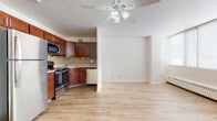 Located at 4801 Sheboygan Ave in Madison, Wisconsin, this single-floor unit offers a practical and well-maintained layout with a cohesive design throughout. Light wood-tone flooring flows consistently across the main living and kitchen areas, contributing to a clean, airy atmosphere. Ceiling fans are present in multiple rooms, providing both functional comfort and a finishing touch to the interior.

The kitchen is a standout feature, equipped with rich warm-toned wood cabinetry, granite countertops, and a mosaic tile backsplash that adds visual interest. Stainless steel appliances — including a range, microwave, dishwasher, and refrigerator — complete the space, making it both attractive and functional. The kitchen opens directly into the living area, creating a connected, open-concept feel.

The living area is generously proportioned, bathed in natural light from a bank of large windows fitted with roll-down shades. A baseboard heating system and wall-mounted HVAC unit provide year-round climate control. An entry hallway with a louvered closet door offers practical storage upon entry.

The bathroom features classic tilework with a mosaic floor, a full-sized soaking tub with shower, and clean, neutral finishes throughout. Overall, the unit presents a bright, move-in ready space with updated finishes in a convenient Madison location.