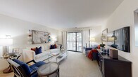 Located at 2509 Brush Rd in Schaumburg, Illinois, this single-floor residence offers a well-organized layout that balances comfort and functionality across its key living spaces. The living room serves as the centerpiece of the home, featuring plush carpeting, neutral walls, and a large sliding glass door that floods the space with natural light and opens directly onto a private balcony overlooking lush greenery. The galley-style kitchen is efficiently designed with rich wood cabinetry, dark granite countertops, a tile backsplash, and stainless steel appliances including a range, microwave, and dishwasher, all set over warm hardwood flooring. Adjacent to the kitchen, the dedicated dining area features hardwood floors, track lighting overhead, and clean white walls accented by decorative wall art, providing an inviting space for meals. The residence includes two carpeted bedrooms, each benefiting from natural light through generously sized windows dressed with curtains. Both rooms offer a calm, restful ambiance. The bathroom features a full tub and shower combination with clean white tile surround. Overall, the space presents a cohesive, comfortable living environment well-suited for everyday life in the Schaumburg area.