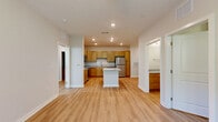 Located at 4420 Nolensville Pike in Nashville, TN, this 2-bedroom, 2-bathroom residence offers a thoughtfully designed single-floor layout with modern finishes throughout. The heart of the home is a bright, open-concept living, dining, and kitchen area anchored by light wood-look luxury vinyl plank flooring and recessed lighting. The well-appointed kitchen features warm-toned shaker-style cabinetry, granite countertops, a central island with additional counter space, and a full suite of stainless steel appliances including a refrigerator, range, microwave, and dishwasher — ideal for both everyday cooking and entertaining. The living area is filled with natural light and provides direct access to a private balcony with tree-lined views. Both bedrooms are generously proportioned, each featuring ceiling fans, large windows, and access to dedicated closets. The spacious primary bedroom includes a sizable walk-in closet with wire shelving. The bathrooms are finished with granite-topped vanities, wood cabinetry, and tub-shower combinations with brushed nickel fixtures. Additional conveniences include a dedicated laundry room, utility room, and five total closets offering exceptional storage throughout the residence.