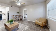 Located at 603 Eagle Dr in Denton, TX, this well-appointed one-bedroom, one-bathroom unit makes smart use of its compact footprint across a single floor. The living room serves as the heart of the home, featuring durable wood-look flooring, a ceiling fan with light fixture, neutral gray walls, and a window that brings in natural light. A dining area sits adjacent, offering an open connection to the rest of the living space.

The kitchen is efficiently designed with white cabinetry, light gray countertops, and black appliances including a range and dishwasher, complemented by light wood-look flooring throughout.

The bedroom is a comfortable retreat with dark wood-look flooring, a textured ceiling, and sliding glass door access to an outdoor area. It also features direct access to the bathroom and an in-unit stacked washer and dryer tucked neatly into a dedicated nook with overhead cabinetry for additional storage.

The bathroom is clean and functional, finished in white tile with a tub-shower combination. A dedicated office space adds versatility, making this unit well-suited for those who work from home. The overall aesthetic is modern and neutral, creating a cohesive and move-in-ready environment.