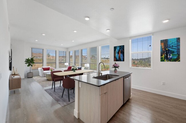 Enjoy the spacious flow of our open concept kitchen and living room, perfect for modern living and entertaining. - Windsor Rancho PQ