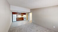 Located at 3863 Memorial Drive in Decatur, GA, this single-floor, one-bedroom, one-bathroom unit offers a practical and functional layout. The open-concept living area flows seamlessly into the kitchen, creating a connected and efficient use of space. The living room features neutral-toned carpet, a textured ceiling, and a wall-unit HVAC system beneath a window that brings in natural light. The front entry door opens directly into this space, providing easy access.

The kitchen is defined by rich, warm-toned wood cabinetry, a white refrigerator, white range, and a skylight-style overhead light fixture that brightens the cooking area. Light wood-style flooring runs throughout the kitchen, transitioning to carpet in the living and bedroom areas.

The bedroom is a comfortable size, featuring carpet flooring, a ceiling fan with integrated lighting, and a window that allows natural light and outdoor views. A hallway connects the main living areas to the bedroom, bathroom, and utility room.

The bathroom includes a white vanity, toilet, and a full tub-shower combination with a curtain rod. Light wood-style flooring carries through the bathroom, complementing the neutral wall tones. The utility room houses a water heater, completing the unit's practical amenities.