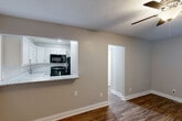 Located at 2216 Dinsmore Dr in Lexington, KY, this well-appointed one-bedroom, one-bathroom unit offers a thoughtfully designed layout that maximizes every square foot. Rich hardwood-style flooring runs throughout the space, providing a warm and cohesive aesthetic that ties each room together.

The combined kitchen and living area forms the heart of the unit. The kitchen features crisp white shaker cabinets, a classic subway tile backsplash, granite countertops with an undermount sink, and black appliances including a range, microwave, and refrigerator. A peninsula-style counter opens directly to the living area, creating an airy, connected feel ideal for both cooking and entertaining.

The spacious bedroom offers ample room with a ceiling fan with light fixture, a wall-mounted HVAC unit, and double closet doors providing generous storage. Natural light filters in through a window with blinds, keeping the room bright and comfortable.

The bathroom is clean and functional, finished with a white vanity, hardwood-style flooring consistent with the rest of the unit, and a linen closet for additional storage. A hallway connects the rooms efficiently, completing the smart flow of the floor plan. Textured ceilings and neutral gray walls throughout give the space a modern, move-in-ready appeal.