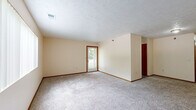Located at 7319 Wirt Cir in Omaha, Nebraska, this single-floor, 3-bedroom, 1-bathroom home offers a practical and straightforward layout connected by a central hallway. The floor plan provides a comfortable sense of space distributed across its rooms.

The three bedrooms are carpeted throughout and finished with neutral, warm-toned walls and wood-trimmed baseboards and door frames. The generously sized primary bedroom is notably spacious, offering ample room for furnishings. The two additional bedrooms are well-proportioned and bright. Several bedrooms feature windows fitted with vertical blinds, allowing natural light to filter in and offering views of the surrounding greenery. One room includes direct access to an exterior door, providing added convenience.

The shared full bathroom is well-appointed, featuring a combination tub and shower, a toilet, and a wood-cabinet vanity with a single sink and mirror. The bathroom is finished with durable wood-look vinyl plank flooring, complementing the warm tones found throughout the home.

A central hallway connects the bedrooms and bathroom, providing an organized and efficient flow through the residence. The textured ceilings and consistent neutral palette give the home a clean, move-in ready appearance. Overall, this home offers a functional and comfortable layout suited for everyday living in a residential Omaha neighborhood.