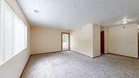 Located at 7319 Wirt Cir in Omaha, Nebraska, this single-floor, 3-bedroom, 1-bathroom home offers a practical and straightforward layout connected by a central hallway. The floor plan provides a comfortable sense of space distributed across its rooms.

The three bedrooms are carpeted throughout and finished with neutral, warm-toned walls and wood-trimmed baseboards and door frames. The generously sized primary bedroom is notably spacious, offering ample room for furnishings. The two additional bedrooms are well-proportioned and bright. Several bedrooms feature windows fitted with vertical blinds, allowing natural light to filter in and offering views of the surrounding greenery. One room includes direct access to an exterior door, providing added convenience.

The shared full bathroom is well-appointed, featuring a combination tub and shower, a toilet, and a wood-cabinet vanity with a single sink and mirror. The bathroom is finished with durable wood-look vinyl plank flooring, complementing the warm tones found throughout the home.

A central hallway connects the bedrooms and bathroom, providing an organized and efficient flow through the residence. The textured ceilings and consistent neutral palette give the home a clean, move-in ready appearance. Overall, this home offers a functional and comfortable layout suited for everyday living in a residential Omaha neighborhood.