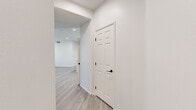 Located at 1500 Cherry St in Placentia, CA, this single-story home offers a clean, modern aesthetic across three bedrooms and four bathrooms. Light wood-look flooring flows consistently throughout the space, complemented by crisp white walls and black hardware accents that lend a contemporary feel.

The kitchen is a standout feature, showcasing white shaker cabinetry extending to the ceiling, a geometric hexagonal tile backsplash, quartz countertops, stainless steel appliances including a range, microwave, dishwasher, and refrigerator, plus a central island ideal for dining or meal prep. Recessed lighting brightens the space efficiently.

The open living area benefits from natural light through large windows with blinds and offers direct outdoor access through a glass-paned door. The primary bedroom is generously sized with a ceiling fan, a walk-in closet with wire shelving, and a private en-suite bathroom. Secondary bedrooms include mirrored sliding-door closets with built-in shelving. The bathrooms are uniformly finished with white vanities, round mirrors, and tub-shower combinations.

A dedicated laundry room accommodates a full-size washer and dryer with overhead wire shelving. Panel doors with matte black hardware complete the cohesive, modern design throughout this well-appointed Placentia home.
