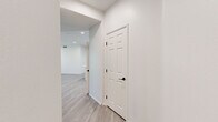 Located at 1500 Cherry St in Placentia, CA, this single-story home offers a clean, modern aesthetic across three bedrooms and four bathrooms. Light wood-look flooring flows consistently throughout the space, complemented by crisp white walls and black hardware accents that lend a contemporary feel.

The kitchen is a standout feature, showcasing white shaker cabinetry extending to the ceiling, a geometric hexagonal tile backsplash, quartz countertops, stainless steel appliances including a range, microwave, dishwasher, and refrigerator, plus a central island ideal for dining or meal prep. Recessed lighting brightens the space efficiently.

The open living area benefits from natural light through large windows with blinds and offers direct outdoor access through a glass-paned door. The primary bedroom is generously sized with a ceiling fan, a walk-in closet with wire shelving, and a private en-suite bathroom. Secondary bedrooms include mirrored sliding-door closets with built-in shelving. The bathrooms are uniformly finished with white vanities, round mirrors, and tub-shower combinations.

A dedicated laundry room accommodates a full-size washer and dryer with overhead wire shelving. Panel doors with matte black hardware complete the cohesive, modern design throughout this well-appointed Placentia home.