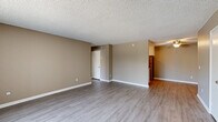 Located at 1435 Elder Avenue in San Diego, CA, this single-floor, 2-bedroom, 1-bathroom home offers a functional and comfortable layout. The open living room is bright and welcoming, featuring light gray wood-style flooring, warm taupe-toned walls, a textured ceiling, and a large window with vertical blinds that invites natural light and outdoor views. The space flows conveniently toward the kitchen, which is efficiently designed with white cabinetry, light stone countertops, and a full suite of stainless steel appliances including a refrigerator, range, and microwave. Both bedrooms are carpeted and feature sliding closets with built-in shelving for storage, along with windows that allow natural light to filter through. The primary bedroom offers a generous footprint, providing ample room for furnishings. The full bathroom is clean and well-appointed, featuring a combined tub and shower with a chrome curtain rod, a white vanity with stone countertop, and wood-style flooring that ties the space together. Throughout the home, consistent neutral tones and clean white trim create a cohesive, move-in-ready aesthetic well-suited for comfortable everyday living.