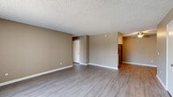 Located at 1435 Elder Avenue in San Diego, CA, this single-floor, 2-bedroom, 1-bathroom home offers a functional and comfortable layout. The open living room is bright and welcoming, featuring light gray wood-style flooring, warm taupe-toned walls, a textured ceiling, and a large window with vertical blinds that invites natural light and outdoor views. The space flows conveniently toward the kitchen, which is efficiently designed with white cabinetry, light stone countertops, and a full suite of stainless steel appliances including a refrigerator, range, and microwave. Both bedrooms are carpeted and feature sliding closets with built-in shelving for storage, along with windows that allow natural light to filter through. The primary bedroom offers a generous footprint, providing ample room for furnishings. The full bathroom is clean and well-appointed, featuring a combined tub and shower with a chrome curtain rod, a white vanity with stone countertop, and wood-style flooring that ties the space together. Throughout the home, consistent neutral tones and clean white trim create a cohesive, move-in-ready aesthetic well-suited for comfortable everyday living.