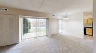 This 660 square foot apartment in Wilmington, Delaware, offers a comfortable living space with modern amenities. The single-floor layout comprises one bedroom, one bathroom, and an open-plan kitchen and living room. The primary bedroom is generously sized at 170 square feet, providing ample space for relaxation. The living area is bright and airy, featuring large sliding glass doors that lead to an outdoor space and allow natural light to flood the room. Plush carpeting throughout adds warmth and comfort. The kitchen boasts light wood cabinetry, dark appliances, and a practical layout with ample counter space. The bathroom is clean and functional, with a shower-tub combination and simple white fixtures. Vertical blinds on the windows offer privacy and light control. The neutral color palette throughout the apartment provides a blank canvas for personalization. This apartment combines functionality with a modern aesthetic, making it an ideal choice for those seeking a cozy yet practical living space in Wilmington.