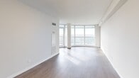 This contemporary 670 square foot condominium in Toronto offers a well-designed living space with two bedrooms and two bathrooms. The open-concept layout maximizes the use of space, creating a seamless flow between the living areas. The kitchen is a standout feature, boasting sleek cabinetry, stainless steel appliances, and a practical breakfast bar with marble countertops.

Floor-to-ceiling windows flood the living room with natural light and provide breathtaking panoramic views of the city skyline. The primary bedroom, measuring 100 square feet, offers ample space and continues the theme of abundant natural light. Both bathrooms are modern and functional, featuring clean lines and neutral tones.

Throughout the condo, light-colored walls and warm wood-tone flooring create a bright and inviting atmosphere. The unit's efficient design incorporates built-in storage solutions and contemporary lighting fixtures. This single-floor residence combines urban sophistication with comfortable living, making it an ideal home for those seeking a stylish city dwelling.