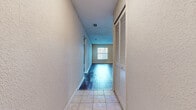 Located at 541 Oak Reserve Ln in Winter Park, Florida, this single-story, 2-bedroom, 1-bathroom home offers a practical and comfortable layout. The living room is a standout space, featuring warm wood-look flooring, neutral-toned walls, a textured ceiling, and large windows with a glass door that fill the room with natural light. The kitchen is well-appointed with light maple cabinetry, rich blue-toned laminate countertops, a complementary tile backsplash, a double-basin stainless steel sink, and a window overlooking the outdoors — providing both functionality and brightness. A central hallway connects the main living areas to the bedrooms, featuring tile flooring and a louvered closet door for convenient storage. Both bedrooms are carpeted and finished with neutral walls and textured ceilings, offering a quiet and comfortable retreat. The primary bedroom provides a generous amount of space. The full bathroom includes a tub-shower combination with white tile surround and clean, simple fixtures. Two closets throughout the home provide ample storage. The overall aesthetic is clean and neutral, offering a move-in-ready canvas in a convenient Winter Park location.