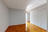 Located at 510 21st St NW, Unit 601, in Washington, DC, this two-bedroom, one-bathroom residence offers a compact yet efficiently designed layout across a single floor. Warm, richly toned parquet hardwood floors flow throughout the living spaces and both bedrooms, lending a classic character to the interior. The primary bedroom is generously proportioned for the unit's footprint, featuring a large window that allows natural light to fill the room, along with a ceiling fan for added comfort. The second bedroom also benefits from its own window and includes built-in closet storage. Neutral gray walls throughout create a clean, versatile backdrop. The bathroom is finished in crisp white tile, featuring a full tub-shower combination, a vanity with sink, and a wall-mounted mirror. A dedicated utility area houses the refrigerator and cabinetry, complemented by gray tile flooring. The unit also includes an in-unit laundry area for added convenience. Two hallways connect the spaces, contributing to a logical and private flow between rooms. The overall ambiance is understated and functional, well-suited for those seeking a practical residence in a prime Northwest Washington, DC location.
