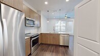 Step into a world of contemporary elegance and effortless living in this beautifully designed studio apartment. The moment you enter, you'll be captivated by the seamless blend of style and functionality that defines every inch of this 440 square foot urban oasis.

The heart of this home is the stunning kitchen, where form meets function in perfect harmony. Sleek wooden cabinetry stretches from floor to ceiling, providing ample storage and creating a warm, inviting atmosphere. Stainless steel appliances, including a side-by-side refrigerator and built-in microwave, add a touch of sophistication while making meal preparation a joy.

The living area is a blank canvas for your imagination, with rich hardwood floors that flow throughout the space, creating a sense of continuity and elegance. Large windows and a glass door leading to a private balcony flood the room with natural light, offering breathtaking views of the surrounding cityscape and creating an atmosphere of openness and possibility.

The bathroom is a serene retreat, featuring a modern vanity with ample storage, a spacious bathtub perfect for relaxing soaks, and gleaming white tile that exudes cleanliness and tranquility. Every detail has been carefully considered to create a space that is both functional and aesthetically pleasing.

A generously sized closet provides plenty of storage for your belongings, ensuring that your living space remains clutter-free and organized. The entire apartment is designed with an eye for detail, from the recessed lighting to the sleek ceiling fan, creating an environment that is both comfortable and stylish.

This studio apartment isn't just a place to live – it's a lifestyle upgrade. It's perfect for the urban professional who values quality, convenience, and modern design. Welcome home to your personal sanctuary in the heart of the city.