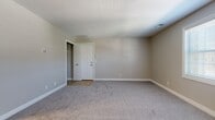 Located at 2025 Key St in Maumee, Ohio, this single-floor unit offers a practical and efficiently designed layout across two bedrooms, one bathroom, a kitchen, a closet, and a dedicated laundry area. The overall footprint is compact yet thoughtfully arranged to maximize usability.

The primary bedroom is notably spacious for the unit's overall size, featuring soft carpet flooring, neutral taupe walls, and a window that allows natural light to filter in. A closet with built-in shelving is accessible directly from the room. The second bedroom is similarly finished with carpet and neutral tones, with its own window providing additional daylight.

The kitchen is equipped with white cabinetry, a coil-burner electric range, and a sink with laminate countertops. Tile flooring runs through the kitchen and connects to adjacent areas. A separate closet with shelving is conveniently located nearby.

The bathroom includes a full tub-shower combination with white tile surround, a vanity with storage, a mirrored medicine cabinet, and tile flooring. The neutral color palette carries throughout the unit, creating a clean, consistent aesthetic. An in-unit laundry area adds practical convenience to this straightforward residential space.